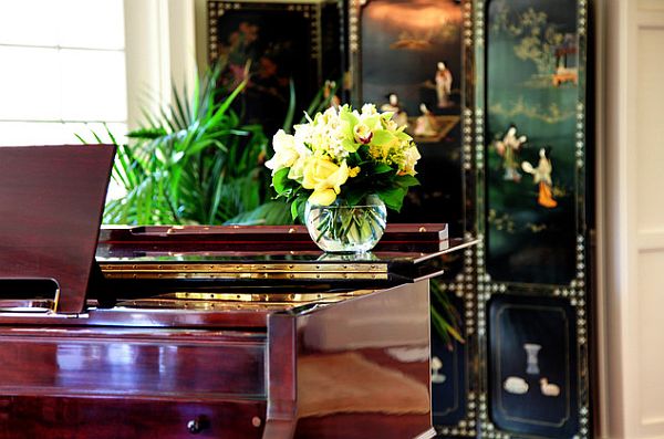 Indoor house plants behind the piano look stylish