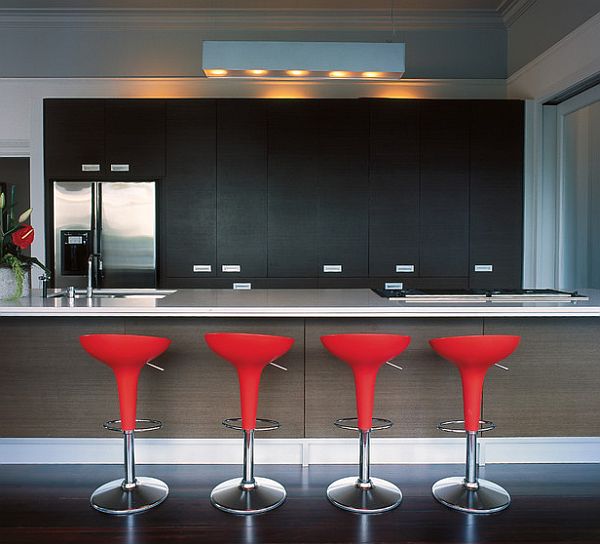 Ultra-modern kitchen with stylish bar stools in red