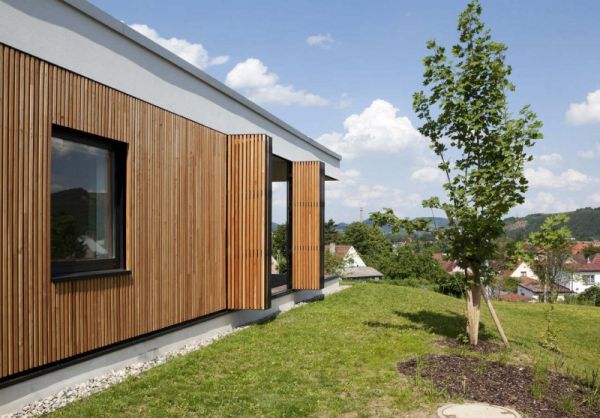 Elegant modern home uses custom wooden shutters in an extravagant manner