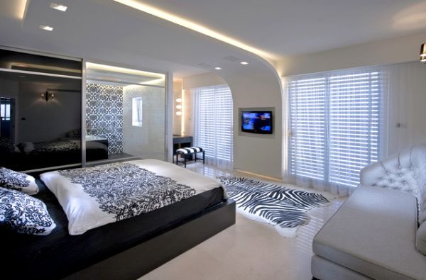 Innovative ceiling design gives this minimalist bedroom a futuristic feel