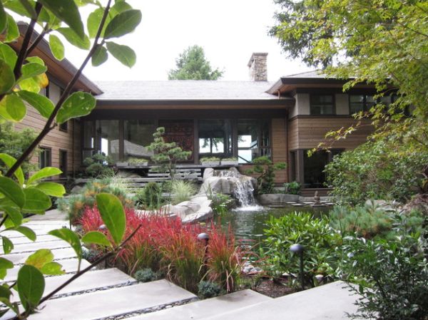 Japanese Blood Grass and pond with lovely waterfalls stand out in this home garden