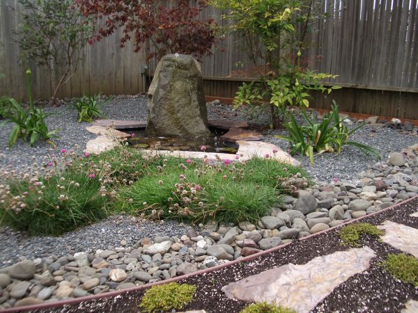 Lovely use of stone and still water in this home Japanese garden