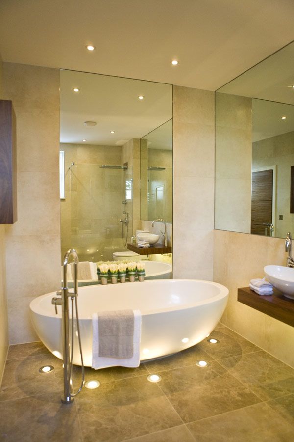Lights in the floor surround this contemporary tub, creating a relaxing atmosphere.