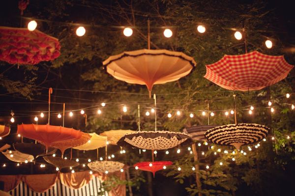 Umbrellas combined with string lightshelp to set the perfect mood.