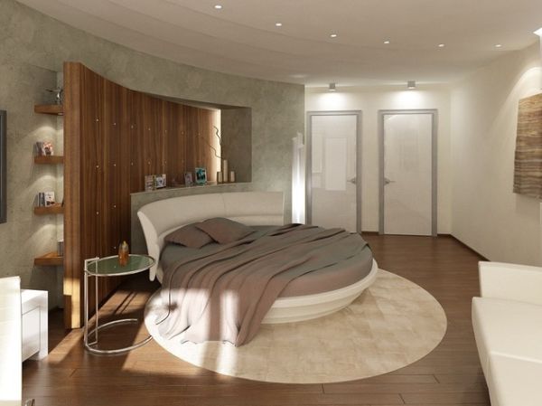 A wooden wall behind the circle bed brings a different textural element