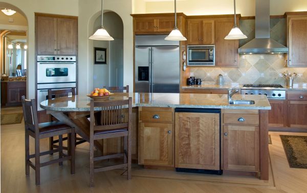 Ambient lighting compliments pendant lights above the kitchen island