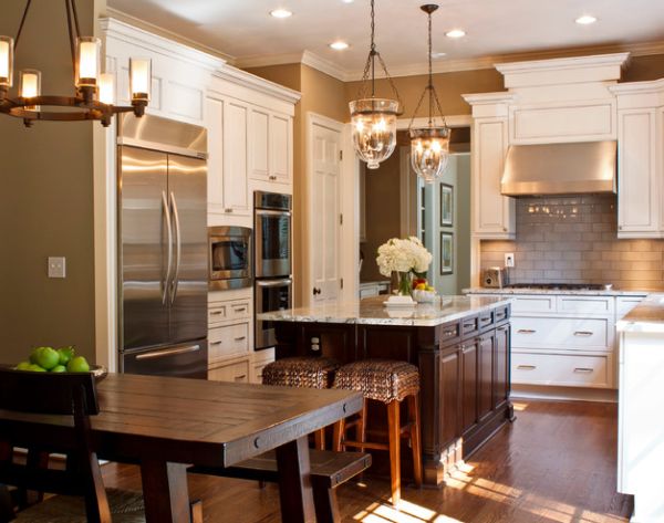 Beautifully illuminated kitchen sports a couple of cool pendant lights