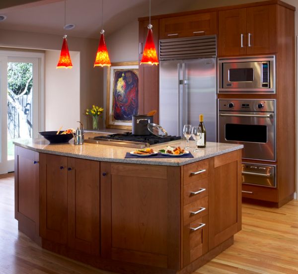 Bright red pendant lights offer a vivid contrast to this largely neutral kitchen