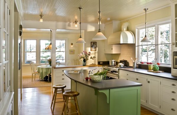 Charming kitchen space with green hues and low-hanging pendant lighting