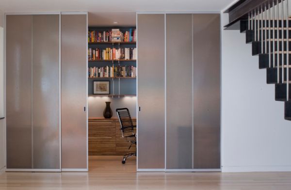 Closet-styled frosted glass doors to tuck away home office space