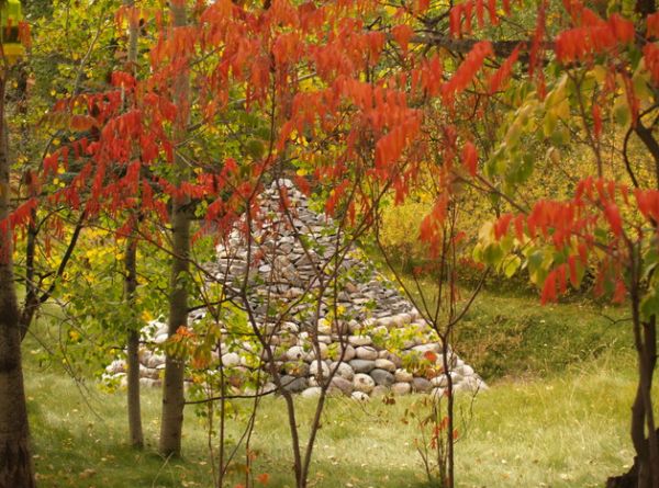 Cone of stones tucked away beautifully in bright red foliage can be appealing art pieces as well