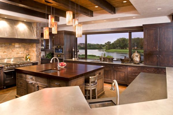 Eclectic modern kitchen with beautiful use of pendant lighting above the island