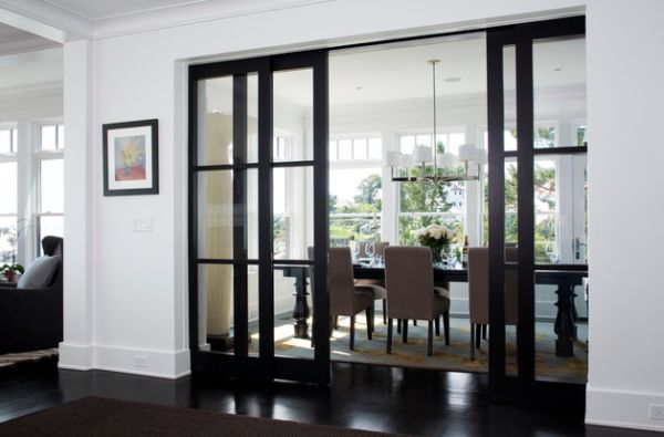 Elegant dining area concealed by sliding glass doors in wooden frame