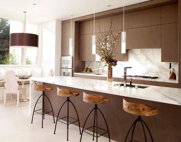 Exquisite modern kitchen in white and brown with sleek pendant lights above the kitchen island