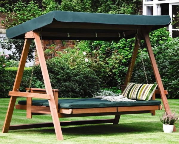 Gorgeous green swing bed in the backyard with shade