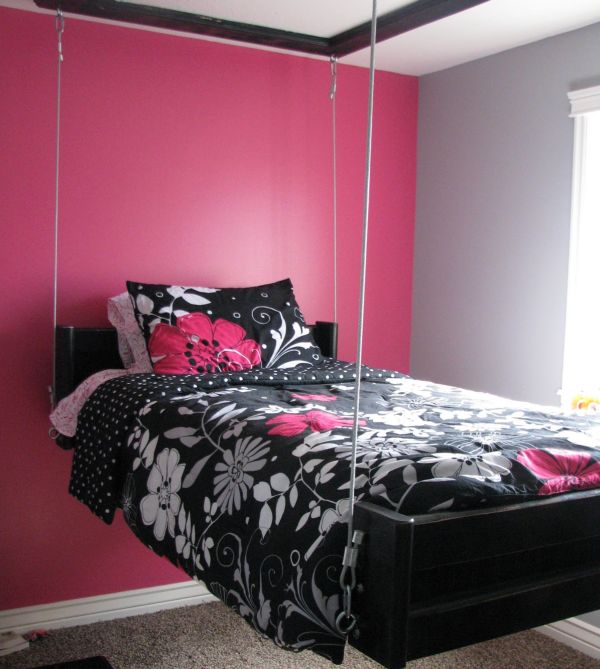 Hanging pinewood bed in a pink setting