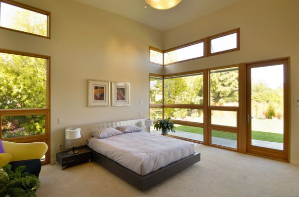 High ceiling and accents of wood add to the beauty of this master bedroom