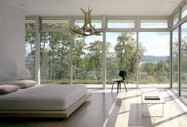 Interesting chandelier and ample views surround this floating bed