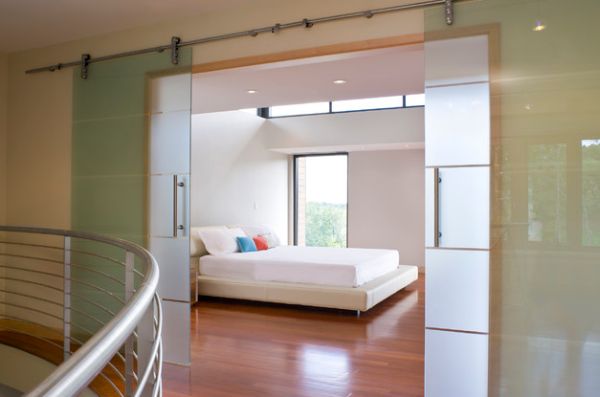 Minimalist bedroom with translucent sliding glass walls