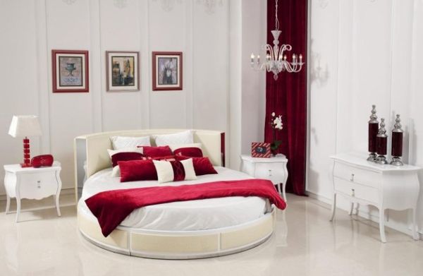 Modern bedroom in a white and red theme with a stylish circle bed