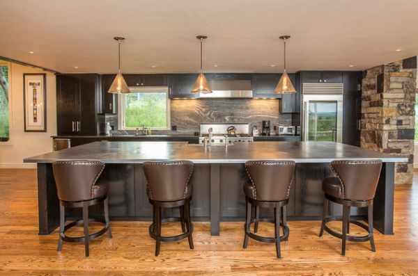 Modern kitchen in dark color scheme with glass door refrigerator