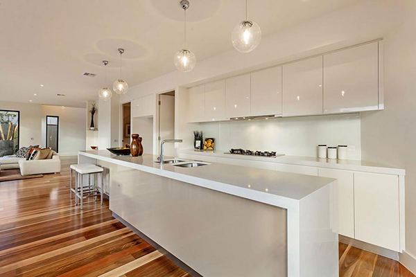 Modern kitchen in white with pendant lights in even number