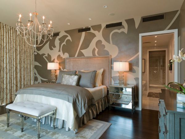 Mural wall, cool chandelier and a tufted bench with acrylic legs make this bedroom unique