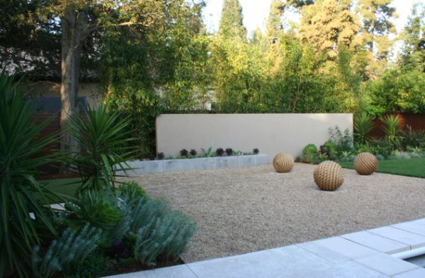 Open rock area with sculptural balls complements all the green around it elegantly