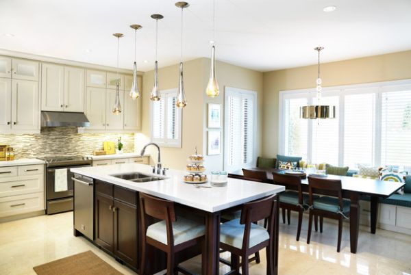 Pendant lights above kitchen island hung at different heights to create a unique look