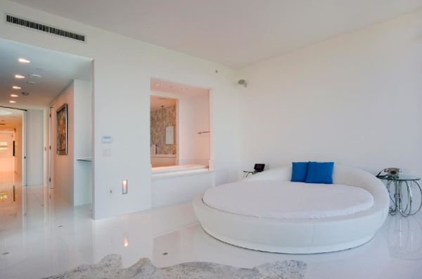 Pristine white room sports an equally classy circle bed