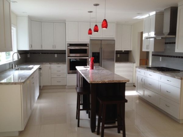 Red glass pendant lights add a touch of color to this kitchen