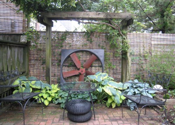 Salvaged industrial fan gives this garden a rustic and unique look