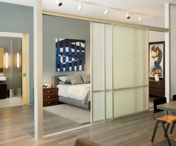 Separation with sliding glass doors and rail lighting for the bedroom