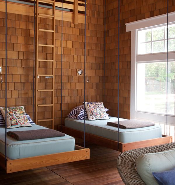 Simple and stylish hanging beds in a room clad in wooden tones