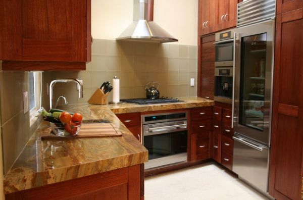 Sleek refrigerator with metal doors nicely used in a kitchen with largely wooden surfaces