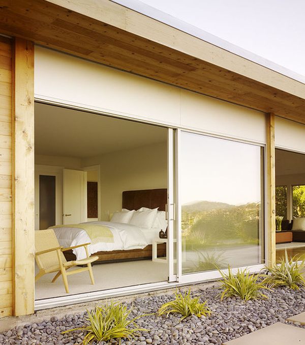 Sliding glass doors bring in freshness into this modern bedroom