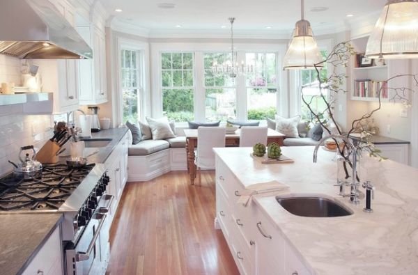 Stunning modern kitchen in pristine white where pendant lights take a rare backseat