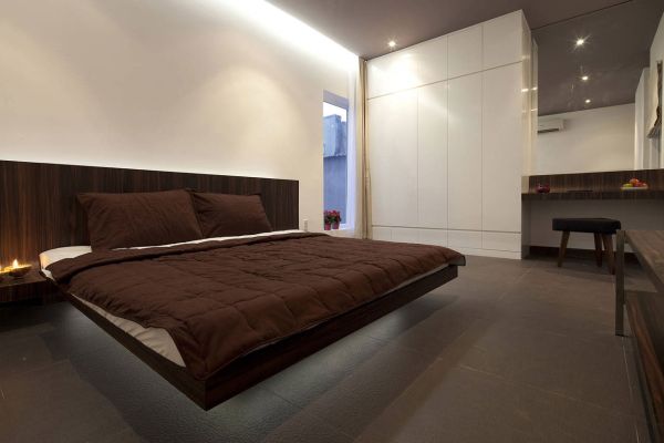 Stylish contemporary bedroom with giant wooden floating bed