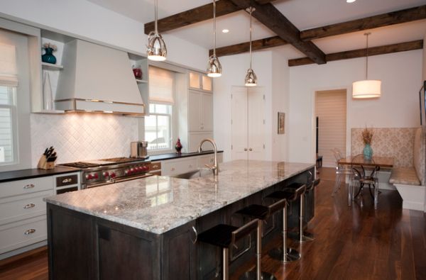 Stylish metal pendant lights above kitchen island with marble countertop