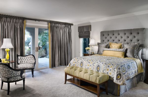Tufted wooden bench offers a textural variation to this bedroom clad in gray