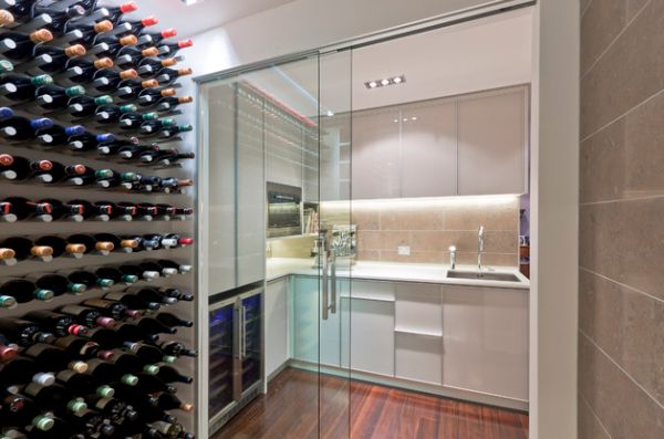 Wine cellar and a small kitchen connected visually using sliding glass doors