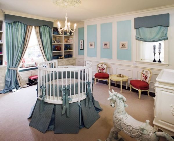 A round crib at the center of the room offers a complete view for the tiny tot