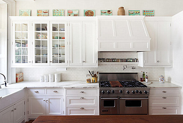 Artwork atop cabinets in a bright kitchen