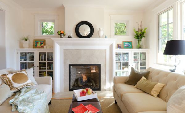 Bookshelves with glass doors flanking the fireplace in the living room