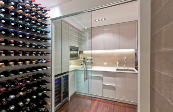 Compact white kitchen separated from wine cellar using sliding glass doors