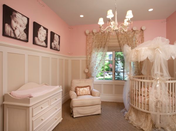 Cute nursery in pink with baby pictures on the wall adding a personal touch