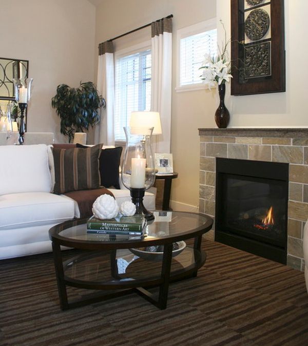 Dark hues of this living room offer a contrast to the glass front fireplace