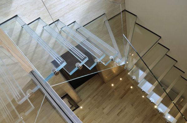 Glass stairs and railing disappear into the backdrop