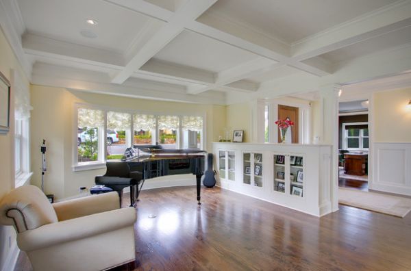 Half wall in the living room doubles up as stylish bookshelf space with glass doors