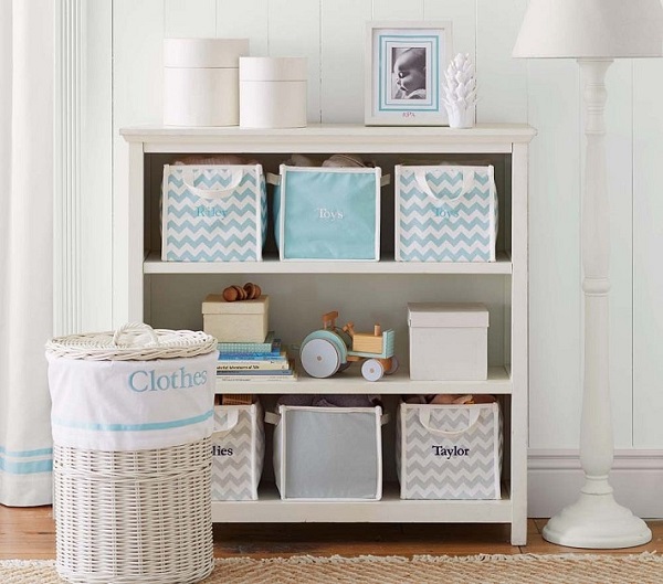 Monogramed canvas storage bins in bookcase